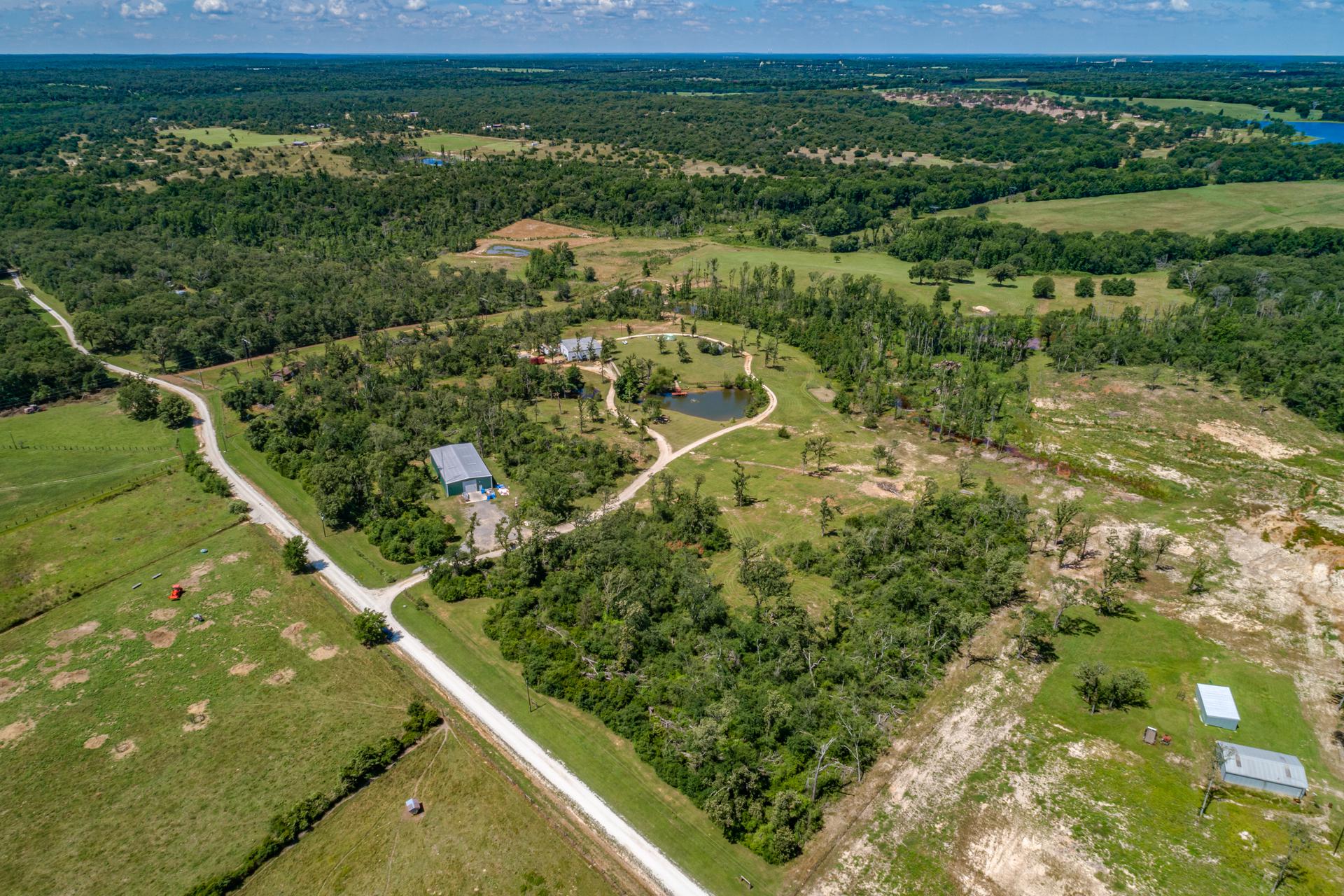 The sprawling 40-acre homesite showing the ponds, garage, warehouses, and outbuilding on the property.